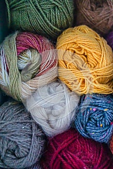 Colorful yarn skeins close up, stacked