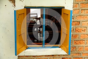 Colorful Yellos and blue Window on old brick wall