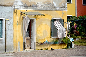 Colorful yellow building corner in Burano, Italy