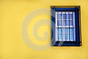 Colorful yellow house with blue shutters and window. In Porto, Portugal
