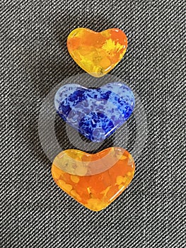 Colorful yellow orange and blue glass heart paperweights