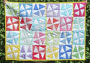 Colorfull baby quilt thirty nine by 27 inches front