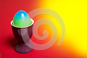 Colorfull easter egg on a yellowred background