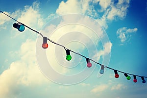 Colorfull lightbulbs against blue sky