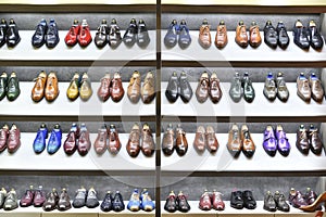 Colorfull pairs of shoes are exposed for sale.