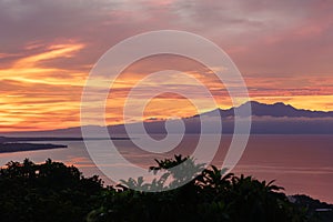 Colorfull sunset behind mountains of tropical island Siqijor