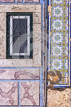 Colorfull traditional decorative tiles, known as asulejos, on a bulding in Lisbon photo