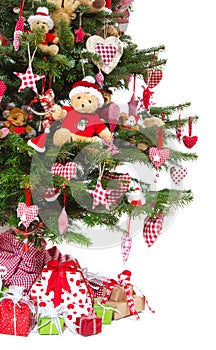 Colorfully decorated isolated Christmas tree with red decoration