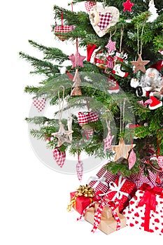 Colorfully decorated isolated Christmas tree with red decoration