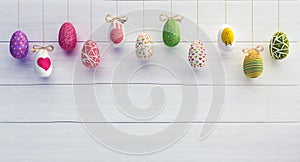 Colorfully Easter eggs on white wood background