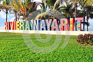 Colorfully painted Riviera Nayarit sign on a public beach in Mexico. Translation: Coastline Nayarit.