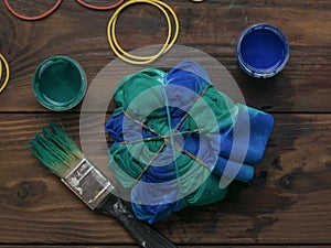 Coloring clothes in the style of tie dye with blue-green color