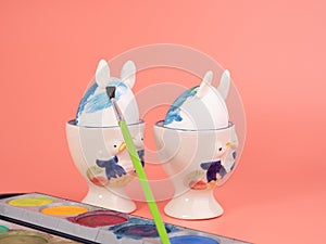 Coloring Easter eggs. Decorate eggs for Easter on a pink background.