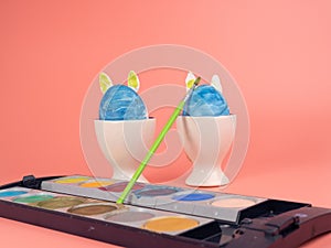 Coloring Easter eggs. Decorate eggs for Easter on a pink background.