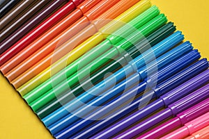 Coloring fibre felt tip pens arranged in a row. Assorted color`s doodling markers