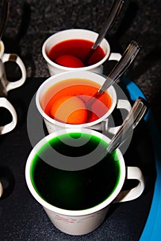 Coloring hard boiled Easter eggs in coffee cups