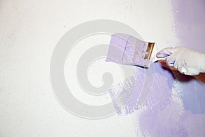 Coloring wall with brush hold by hand