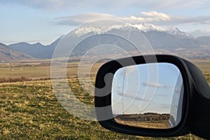 The Colors of countryside as seen from car mirror.