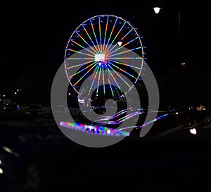the colors of the ferris wheel in the evening
