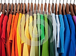 Colors of rainbow, clothes on wooden hangers photo