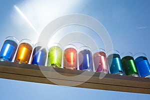 Colors in the Sky - Color Water in shot glasses with the sun shining through