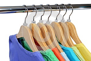 Colors t-shirts hang on closing rack isolated on white