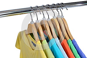 Colors t-shirts hang on closing rack isolated on white