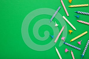 Coloruful birthday candles on green background. Birthday celebration. Spsce for text