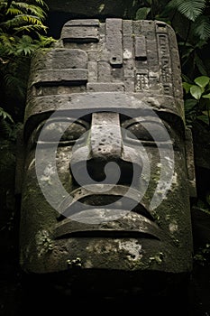 Colossal Olmec Head stone statue. Isolated against a black background. Cracked stone. Intricate detailed carving.