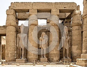 Colossal statues of Ramesses II between papyrus-bud columns in the Ramesses II Court of the Luxor Temple.