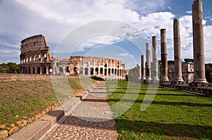 Colosseo and venus temple columns and path view from Roman forum photo
