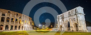 Colosseum and Arch of Constantine at night in Rome, Italy