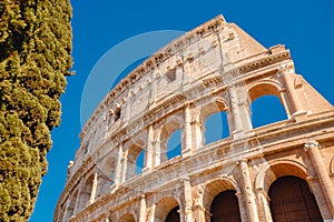 Colosseum or Coliseum ancient ruins background blue sky Rome, Italy, stone arches and sunset