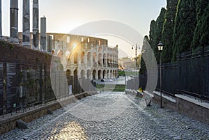 Colosseum (Coliseum) building and columns of Roman Forum, Rome, Italy