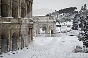 Colosseum and Costantine's Arch in the snow photo