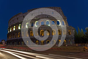 The Colosseum or Roman Coliseum at dusk with streaked car lights, originally the Flavian Amphitheatre, an elliptical amphitheatre