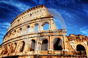 Colosseum in Rome, Italy. Amphitheatre over deep blue sky