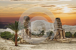 Colossus of Memnon sits in a field