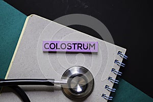 Colostrum text on sticky notes. Office desk background. Medical or Healthcare concept