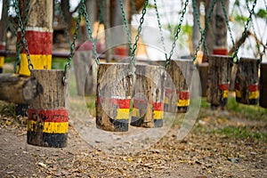Colouful wooden swings in row. Outdoor children playground