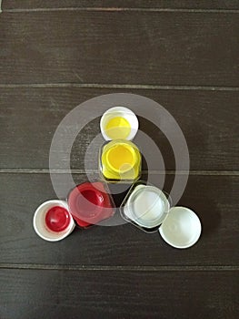 Colour botals are in triangle shape yellow white and red colour with nice wooden background