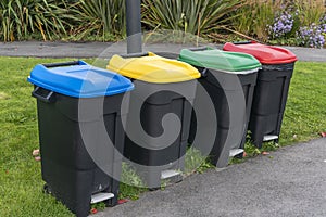 Colour coded black recycle bins photo