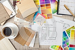 Colour palettes with house plan on desk top view. Designer working at new project