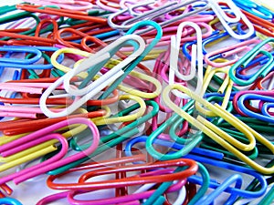 Colour paper clips in a pile photo