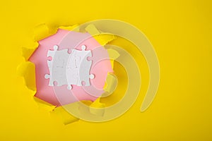 Colour ripped  paper with uncompleted white puzzle