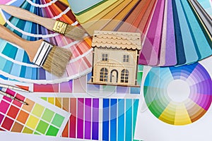Colour swatch with wooden house model close up