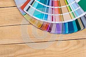 Colour swatches in fan on wooden background