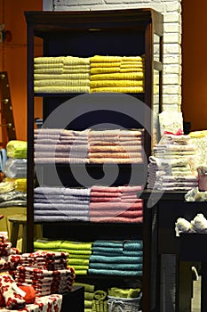 Colour towel stacked neatly on the shelf in fashion shop