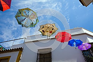 Colour umbrellas on street of old Cordoba, Spain