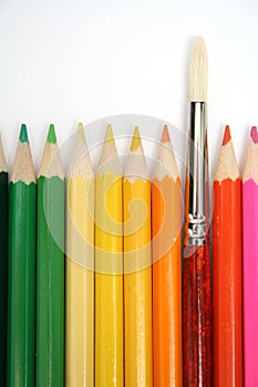 Colour wooden pencils around of an art brush